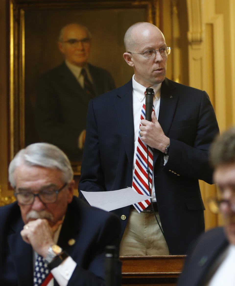 Virginia Del. Rob Bell, R-Albermarle, top, Chairman of the Courts of Justice Committee, announces that he will call a hearing with the two accusers and Lt. Gov Justin Fairfax to hear their accusations during the House session at the Capitol in Richmond, Va., Friday, Feb. 22, 2019. (AP Photo/Steve Helber)