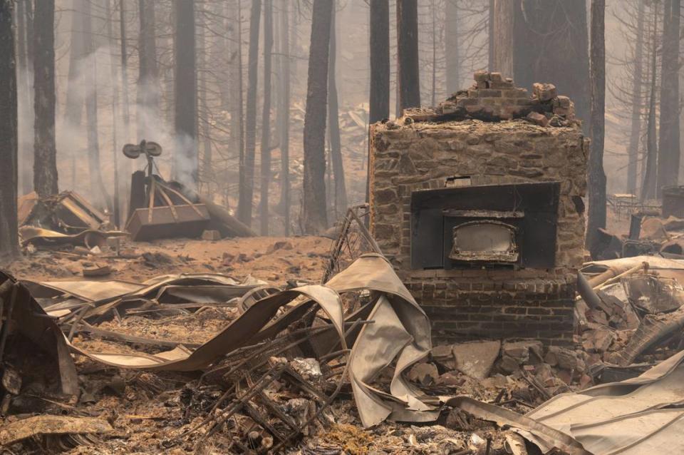 A burned fireplace is all that remains of a home near Sierra-at-Tahoe ski resort in the Eldorado National Forest after the Caldor Fire passed through the area along Highway 50 in 2021.