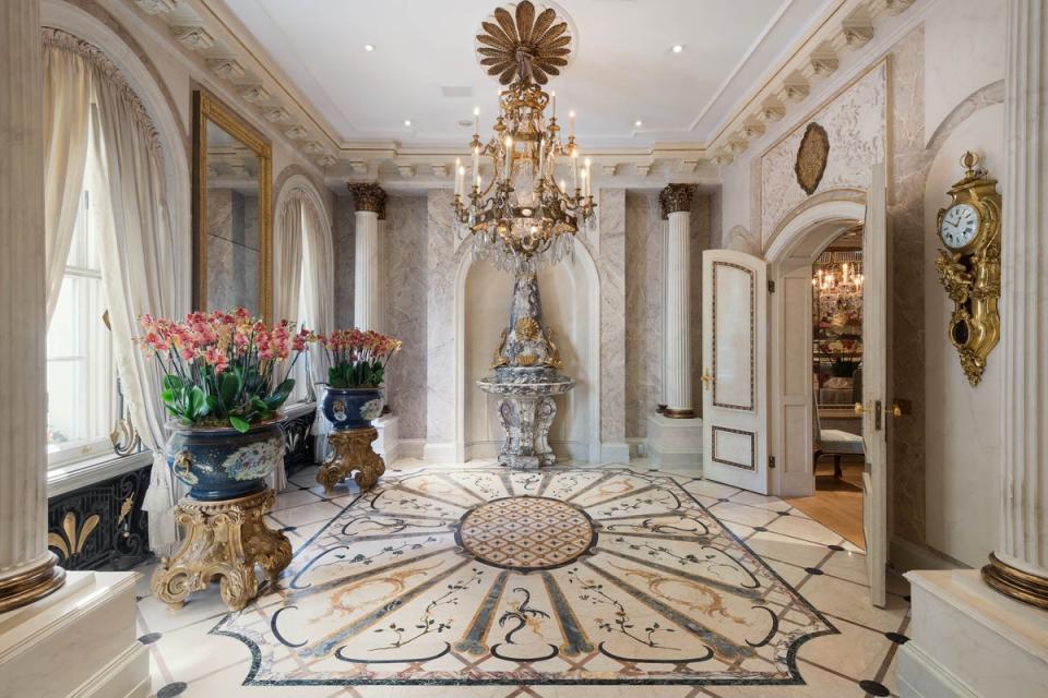 The reception hall features an inlaid marble floor and Corinthian columns (Alex Winship Photography)