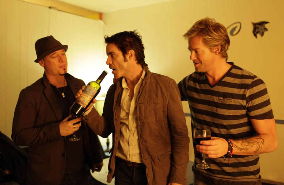 In this photo taken Wednesday April 11, 2012, from left, Jimmy Stafford, Patrick Monahan, and Scott Underwood of the band Train sample some of their wine before their concert at the Great American Music Hall in San Francisco. (AP Photo/Eric Risberg)