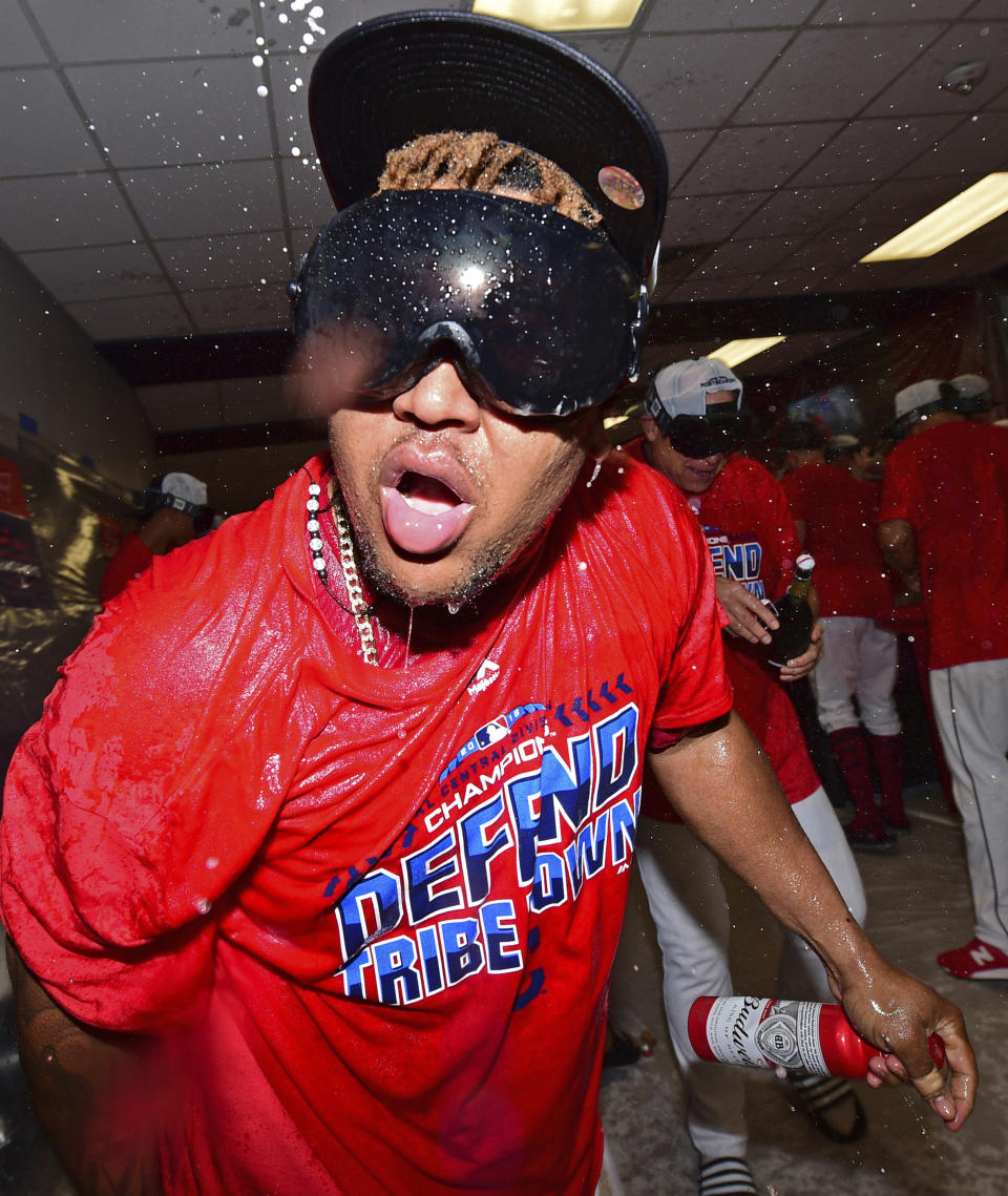 Cleveland Indians Jose Ramirez celebrates in the clubhouse after the Indians defeated the Detroit Tigers 15-0 to clinch the American League Central Division, in a baseball game, Saturday, Sept. 15, 2018, in Cleveland. (AP Photo/David Dermer)