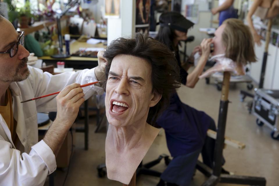 Paris' Grevin Wax Museum painter Bruneau works on the head of Rolling Stones lead singer Mick Jagger at their workshop in Paris