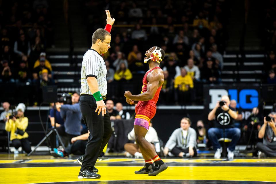 Iowa State's Paniro Johnson, right, reacts after scoring a takedown in overtime against Iowa on Dec. 4, 2022, at Carver-Hawkeye Arena in Iowa City.