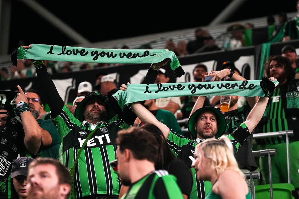 Austin FC fans Ryan Palumbo, left, and Doron Silberstein hold up scarves during a game at Q2 Stadium in February. The club is valued at $800,000, sixth-best in Major League Soccer.
