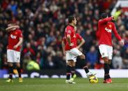 (L to R) Manchester United's Phil Jones, Javier Hernandez and Robin van Persie react during their English Premier League soccer match against Newcastle United at Old Trafford in Manchester, northern England December 7, 2013. REUTERS/Darren Staples