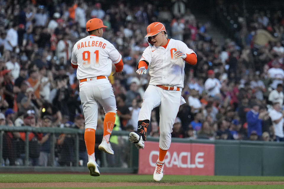 San Francisco Giants' Joc Pederson, right, celebrates with third base coach Mark Hallberg (91) after hitting a two-run home run against the New York Mets during the third inning of a baseball game in San Francisco, Tuesday, May 24, 2022. (AP Photo/Tony Avelar)