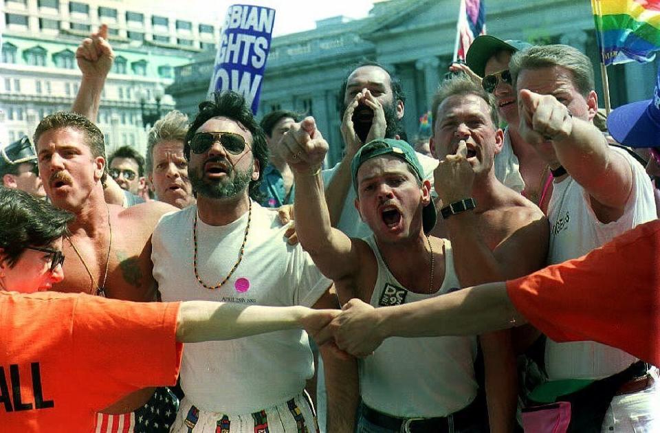 WASHINGTON, DC - APRIL 25:  Participants in the 25 April 1993 gay rights march, held back by a line of parade marshals, scream and yell at a number of religious counter-demonstrators along the parade route. Hundreds of thousands of gay men and women joined in the march and rally to demand acceptance and equal rights.  (Photo credit should read ARYEH RABINOVICH/AFP/Getty Images)