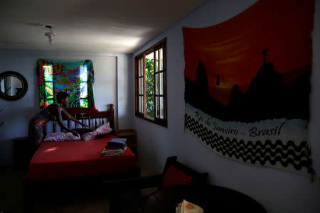 Solange, a worker at Pousada Favelinha (Little favela) hostel, prepares a room in Pereira da Silva favela, in Rio de Janeiro, Brazil, April 21, 2016. REUTERS/Pilar Olivares