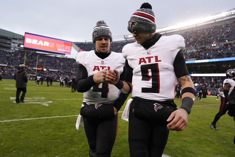Atlanta Falcons quarterback Taylor Heinicke (4) and Atlanta Falcons quarterback Desmond Ridder (9) walk off the field after a loss to the Chicago Bears after an NFL football game in Chicago, Sunday, Dec. 31, 2023. (AP Photo/Charles Rex Arbogast)
