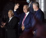 Montreal Canadiens legends Yvan Cournoyer, left, Guy Lafleur, center, and Patrick Roy, right, salute the crowd prior to first period Game 4 Stanley Cup finals action between the Montreal Canadiens and the Tampa Bay Lightning, in Montreal, Monday, July 5, 2021. Montreal Canadiens legend Guy Lafleur has died at age 70. (Ryan Remiorz/The Canadian Press via AP)