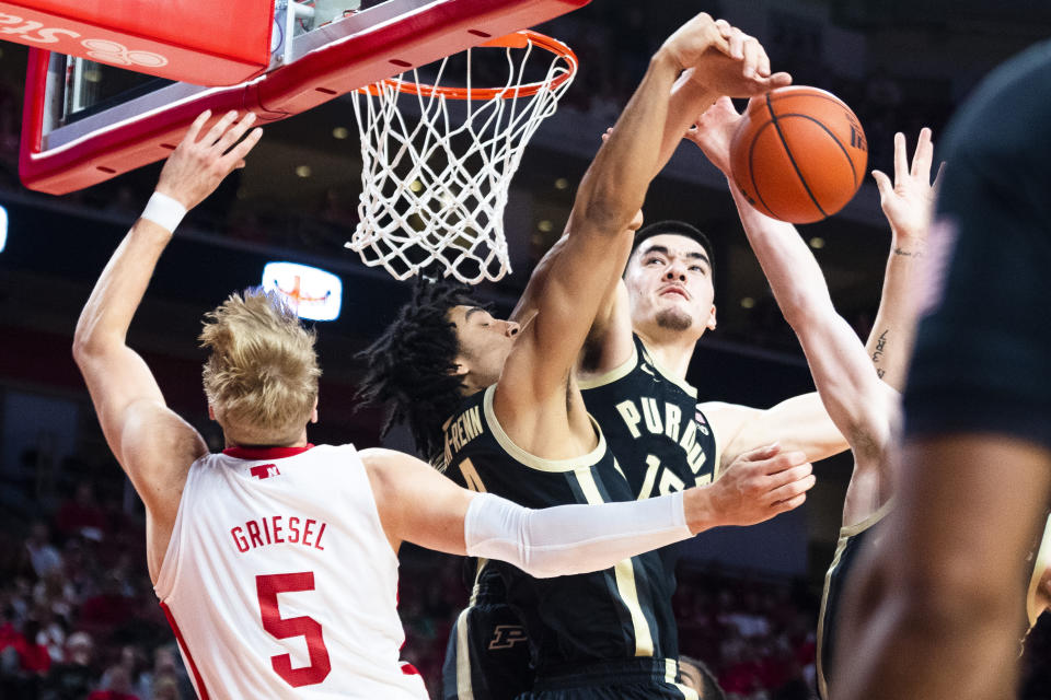 Nebraska's Sam Griesel is blockjed by Purdue's Trey Kaufman-Renn, center, and Zach Edey, right, during the first half of an NCAA college basketball game, Saturday, Dec. 10, 2022, at Pinnacle Bank Arena in Lincoln, Neb. (Kenneth Ferriera/Lincoln Journal Star via AP)