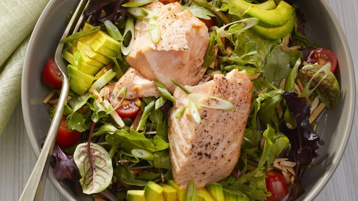 a bowl of salad with salmon for weight loss