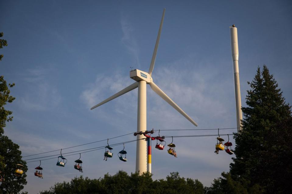 Fairgoers ride the Sky Glider past a wind turbine during the Iowa State Fair in Des Moines, on Aug. 10.<span class="copyright">Al Drago—Bloomberg/Getty Images</span>