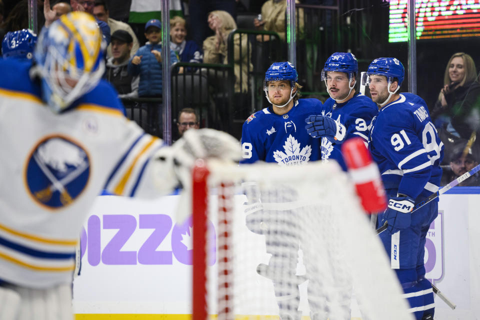 Toronto Maple Leafs centre Auston Matthews (34) celebrates his goal against the Buffalo Sabres with William Nylander (88) and John Tavares (91) during the second period of an NHL hockey game Saturday, Nov. 4, 2023, in Toronto. (Christopher Katsarov/The Canadian Press via AP)