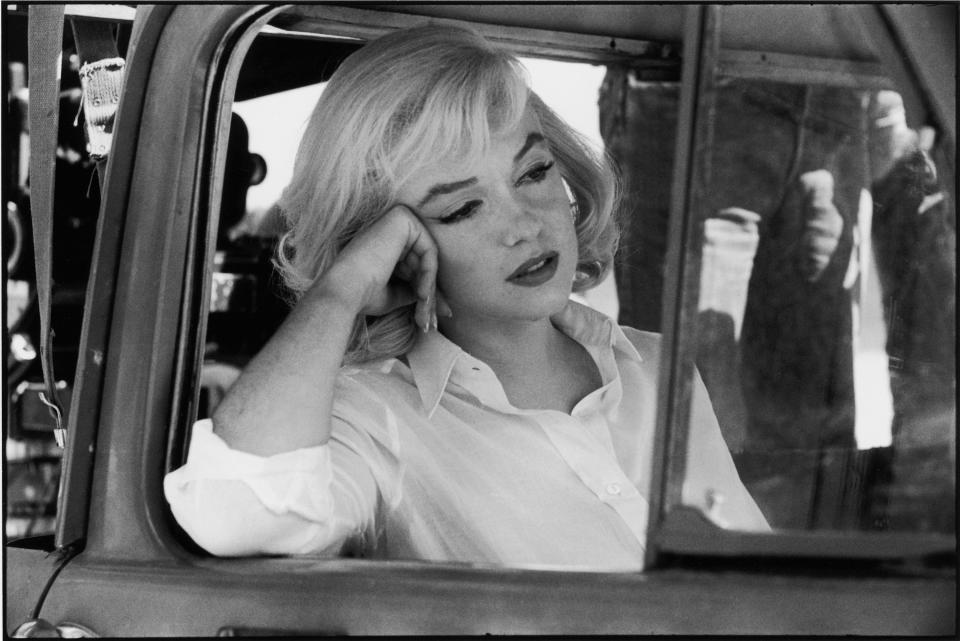 Marilyn Monroe as Roslyn sits in a car while filming "The Misfits"