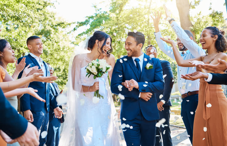 A couple celebrating after getting married. Wedding insurance helped them get protected against certain risks.