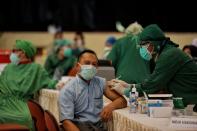 An Indonesian healthcare worker receives a dose of Sinovac's vaccine for coronavirus disease (COVID-19) in Sleman, Yogyakarta