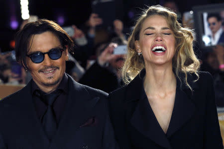 Actor Johnny Depp and girlfriend Amber Heard laugh as they arrive for the UK premiere of "Mortdecai" at Leicester Sqaure in London January 19, 2015. REUTERS/Luke MacGregor