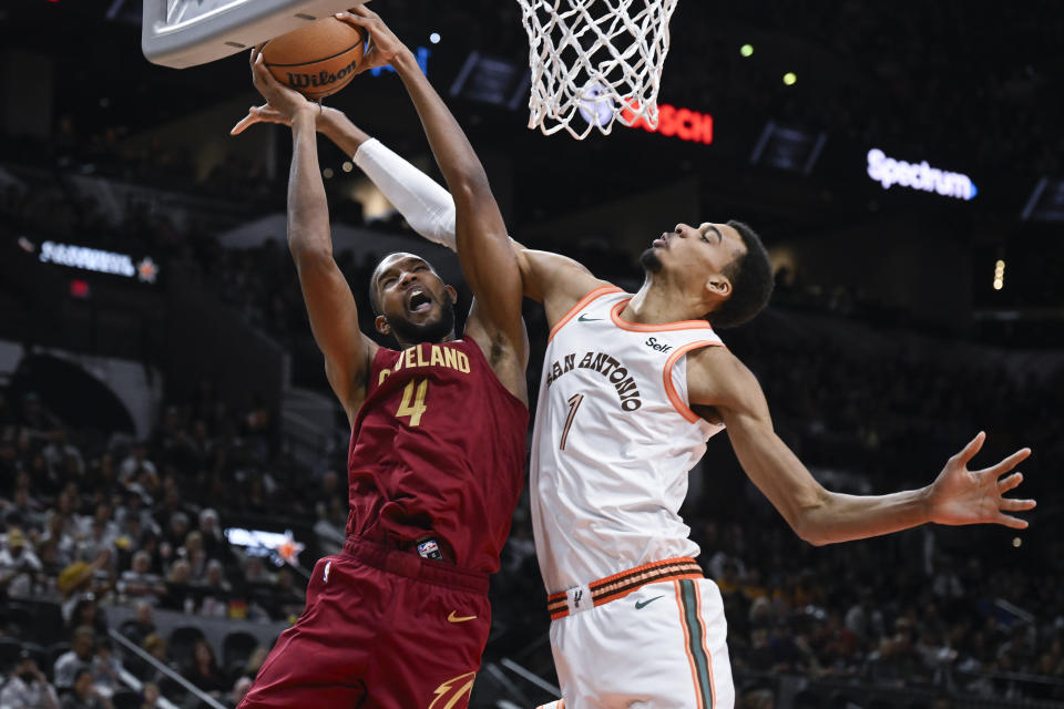 Cleveland Cavaliers' Evan Mobley (4) attempts to shoot against San Antonio Spurs' Victor Wembanyama (1) during the first half of an NBA basketball game, Saturday, Feb. 3, 2024, in San Antonio. (AP Photo/Darren Abate)