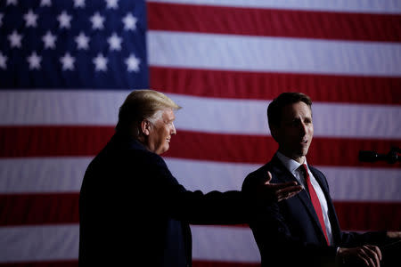 Republican nominee for U.S. Senate Josh Hawley shares the stage with U.S. President Donald Trump (L) during a campaign rally at the Columbia Regional Airport in Columbia, Missouri, U.S., November 1, 2018. REUTERS/Carlos Barria