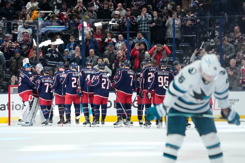 Jan 21, 2023; Columbus, Ohio, USA;  Teammates line up to hug Columbus Blue Jackets goaltender Joonas Korpisalo (70) following their 5-3 win over the San Jose Sharks in the NHL hockey game at Nationwide Arena. Mandatory Credit: Adam Cairns-The Columbus Dispatch