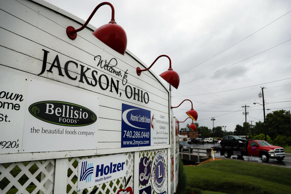 Traffic passes along a main thoroughfare as rain clouds gather overhead, Wednesday, July 17, 2019, in Jackson, Ohio. Newly released prescription opioid statistics underscore how widespread pill use has been in towns and small cities of America’s Appalachian region. In Jackson County, an average yearly total of 107 opioid pills for every resident were distributed over a seven-year period. (AP Photo/John Minchillo)