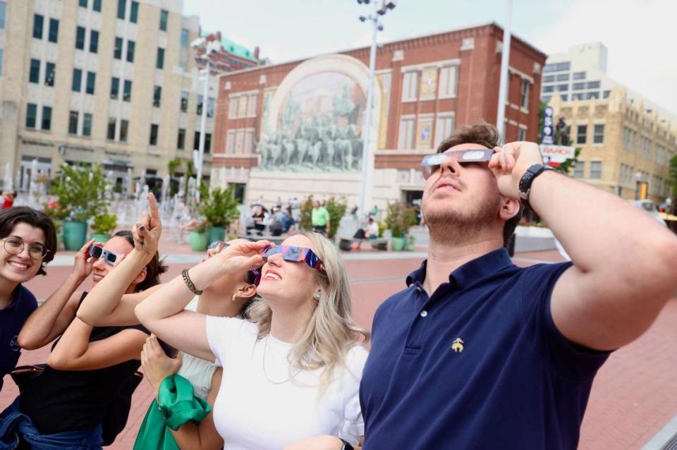 Downtown workers take a moment to look at eclipse in Fort Worth’s Sundance Square on Monday, April 8, 2024. Amanda McCoy/amccoy@star-telegram.com
