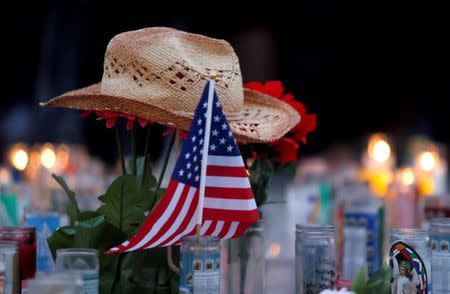 FILE PHOTO: A hat rests on flowers in a makeshift memorial during a vigil marking the one-week anniversary of the October 1 mass shooting in Las Vegas, Nevada U.S. October 8, 2017. REUTERS/Las Vegas Sun/Steve Marcus/File Photo