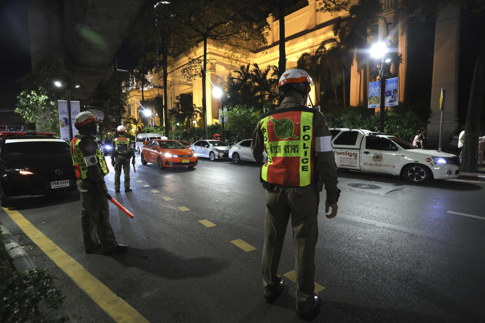 Police officers stand outside the Grand Hyatt Erawan Hotel in Bangkok, Thailand, Tuesday, July 16, 2024. Police said a number of people were found dead Tuesday in the luxury hotel in downtown Bangkok and poisoning is suspected. (AP Photo/Chatkla Samnaingjam)