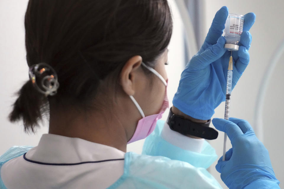 A health worker prepare a dose of the Moderna COVID-19 vaccine Wednesday, June 30, 2021, in Sumida ward of Tokyo. (AP Photo/Eugene Hoshiko)