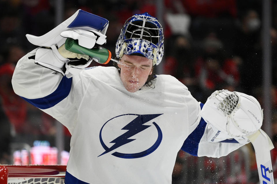 Tampa Bay Lightning goaltender Andrei Vasilevskiy (88) sprays his face with water during a break in the action in the first period of an NHL hockey game against the Washington Capitals, Saturday, Oct. 16, 2021, in Washington. (AP Photo/Nick Wass)