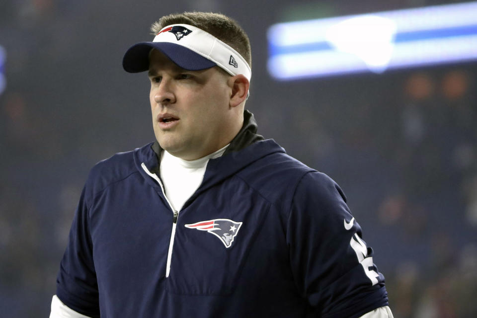 FILE - In this Jan. 4, 2020, file photo, New England Patriots offensive coordinator Josh McDaniels watches his team warm up before an NFL wild-card playoff football game against the Tennessee Titans, in Foxborough, Mass. With the Carolina Panthers and New York Giants completing coaching hires on Tuesday, Jan. 7, 2020, the Cleveland Browns job vacancy will be the last NFL opening filled. It's still unclear how quickly that will happen. The Browns, who fired Freddie Kitchens after just one season, are in the second week of interviews and have scheduled meetings this week with Patriots offensive coordinator Josh McDaniels and Vikings coordinator Kevin Stefanski. (AP Photo/Elise Amendola, File)