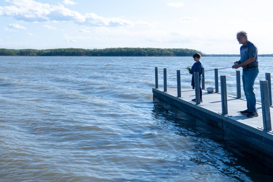 Lawrence resident Steve Unruh casts a line Friday with his grandson Ryder Smith, 8, from a dock at Clinton State Park.