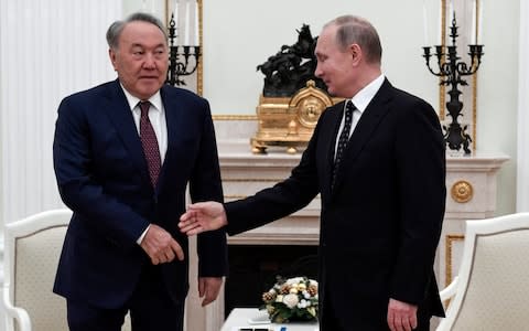 Mr Nazarbayev meets with Vladimir Putin in December. He has tried to gently assert Kazakhstan's independence from its former overlord - Credit: Alexander Nemenov/Pool Photo via AP