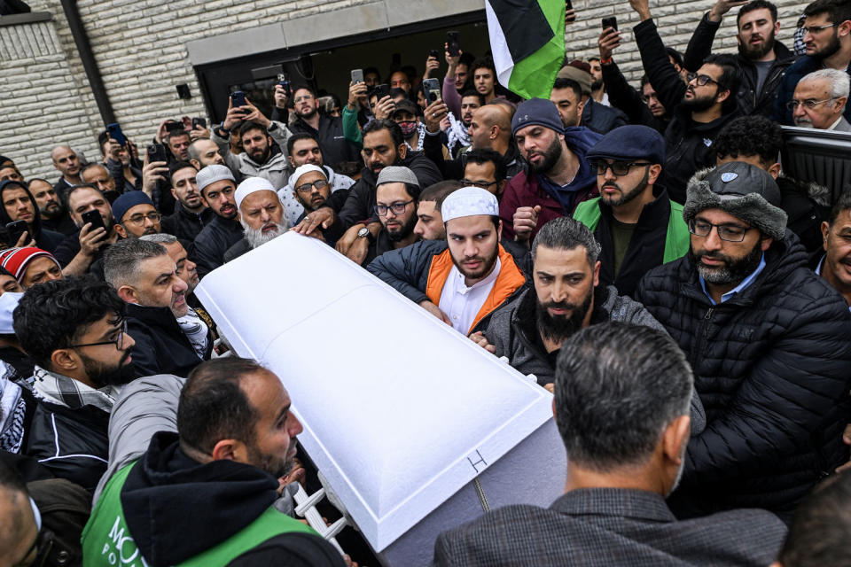 Oday Al-Fayoumi (bottom right of casket) holds the casket with the remains of his 6-year-old Palestinian American son Wadea Al-Fayoumi after a prayer service in Bridgeview, Ill. on Oct. 16, 2023.  Wadea Al-Fayoumi and his mother Hanaan Shahin were stabbed several times by their landlord Joseph Cuba as he yelled anti-Muslim statements at their home in Plainfield, Illinois. (Joshua Lott / The Washington Post via Getty Images)