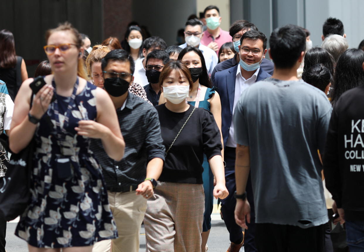 Office workers go for lunch in the central business district during the novel coronavirus pandemic in Singapore on 26 April, 2022. (PHOTO: Reuters)