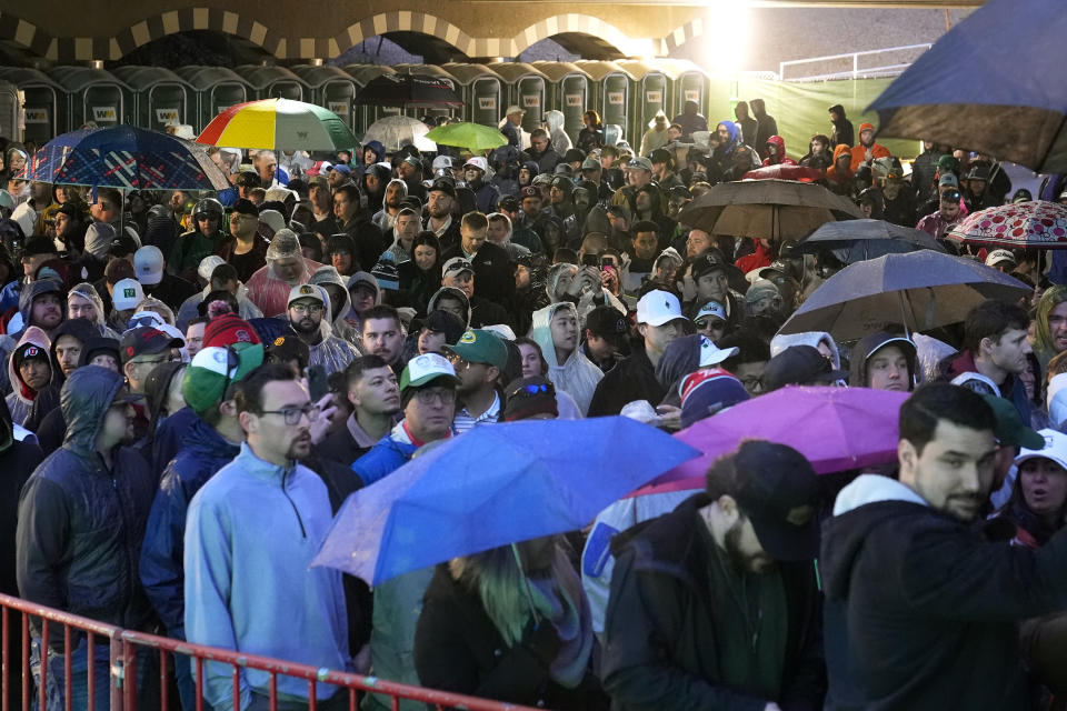 Fans wait to walk onto the course prior to the continuation of second round of the Phoenix Open golf tournament Saturday, Feb. 10, 2024, in Scottsdale, Ariz. (AP Photo/Ross D. Franklin)