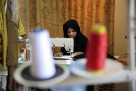 An Afghan woman tailor works with a sewing machine in the Afghan Women Business Hub in Kabul, Afghanistan, Tuesday, July 2, 2024. Half of Afghanistan's population now finds itself locked out of the freedom to work at a time when the country's economy is worse than ever, with few jobs available to women in the country. (AP Photo/Siddiqullah Alizai)