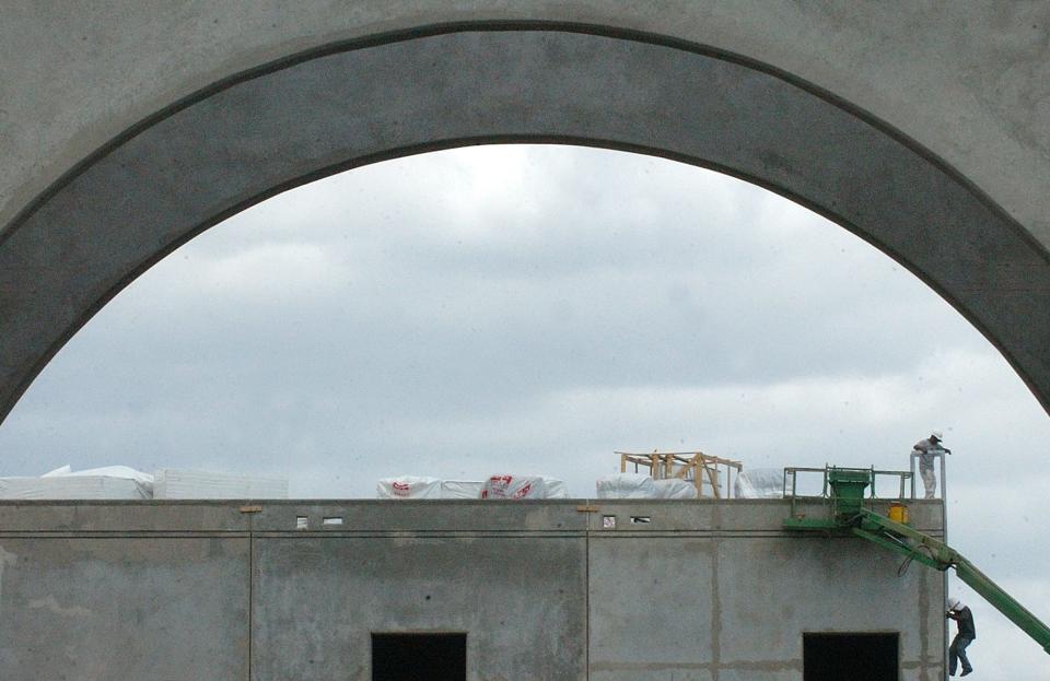FILE: In this 2006 photo, workers descend the steps from the roof of the City of Cape Coral Charter Middle School on Oasis Blvd.