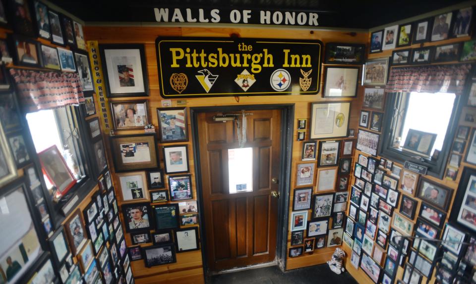 Photos and letters from service members cover the walls of the Pittsburgh Inn front entryway.