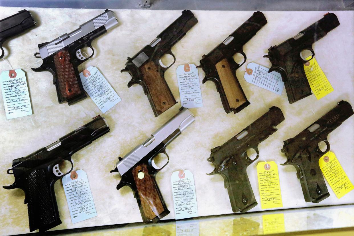 In this July 10, 2013 file photo, semi-automatic handguns are seen display for purchase at Capitol City Arms Supply in Springfield, Ill. According to Illinois State Police figures released Friday, Jan. 16, 2015, more than 91,000 concealed-carry permits have been issued in Illinois since the state began allowing guns to be carried in public a year ago. (AP Photo/Seth Perlman, File)