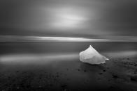 <b>Honorable Mention: East of Iceland</b> <br> Glacial ice washes ashore after calving off the Breiamerkurjˆkull glacier on Iceland's eastern coast. During the waning light of summer this image was created over the course of a 4 minute exposure while the photographer backlit the grounded glacial ice with a headlamp for 2 of those 4 minutes. <a href="http://ngm.nationalgeographic.com/ngm/photo-contest/" rel="nofollow noopener" target="_blank" data-ylk="slk:(Photo and caption by Eric Guth/National Geographic Photo Contest);elm:context_link;itc:0;sec:content-canvas" class="link ">(Photo and caption by Eric Guth/National Geographic Photo Contest)</a>