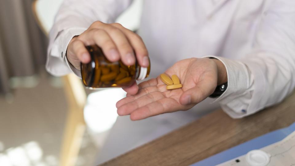 man hand taking medicine