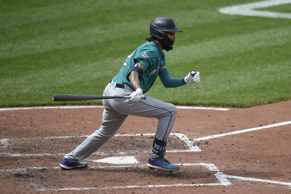 Seattle Mariners' J.P. Crawford follows through on a two run double against the Baltimore Orioles in the sixth inning of the first game of a baseball doubleheader, Thursday, April 15, 2021, in Baltimore. (AP Photo/Gail Burton)