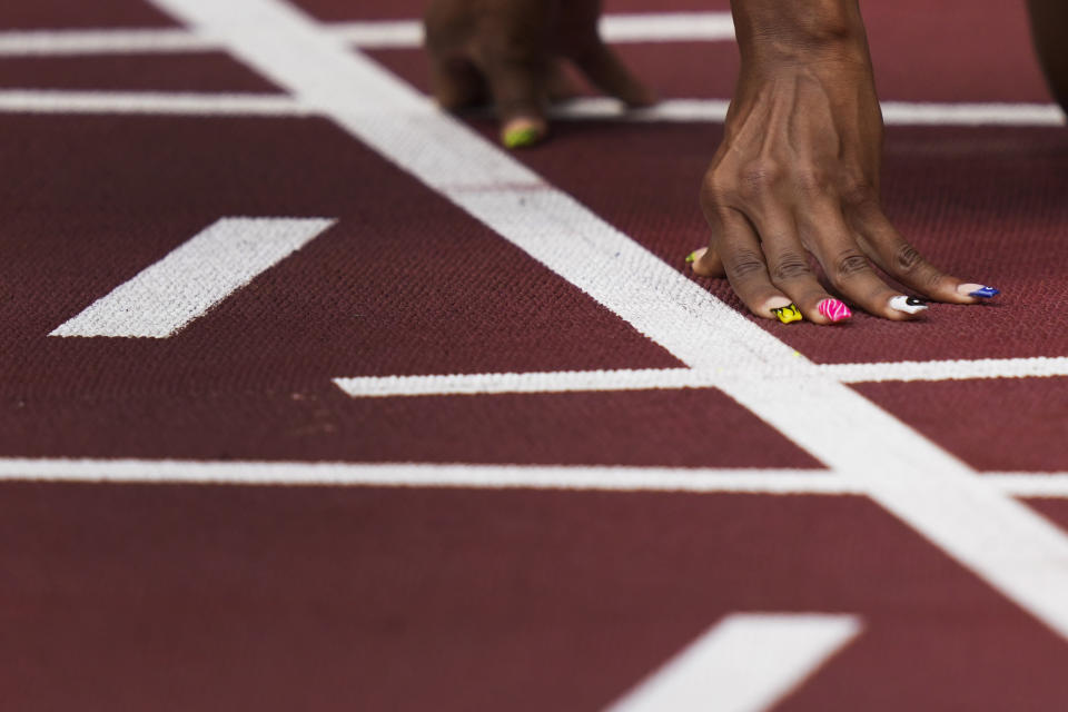 Javianne Oliver, of United States, prepares to start in her heat of the women's 100-meters at the 2020 Summer Olympics, Friday, July 30, 2021, in Tokyo. (AP Photo/Matthias Schrader)