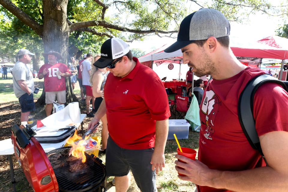 Johnny Morgan and Blake Davis grill food for their tailgate on the Quad at the University of Alabama before the Sept. 24, 2022, game with Vanderbilt.