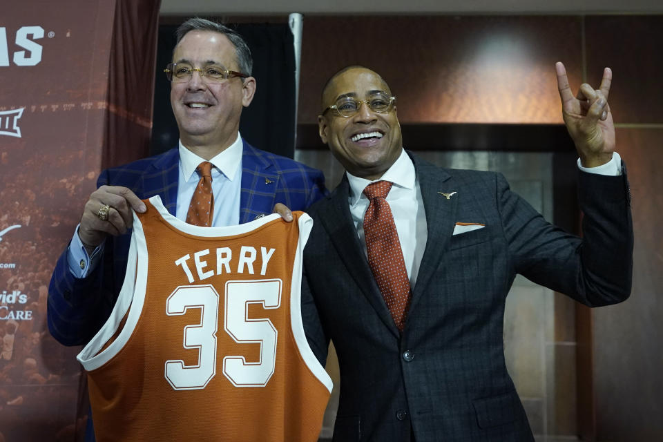 New Texas NCAA college basketball head coach Rodney Terry, right, poses for a photo with Texas Athletic Director Chris Del Contem during a news conference in Austin, Texas, Tuesday, March 28, 2023. (AP Photo/Eric Gay)