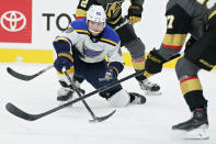 St. Louis Blues center Ivan Barbashev (49) vies for the puck against the Vegas Golden Knights during the third period of an NHL hockey game Tuesday, Jan. 26, 2021, in Las Vegas. (AP Photo/John Locher)