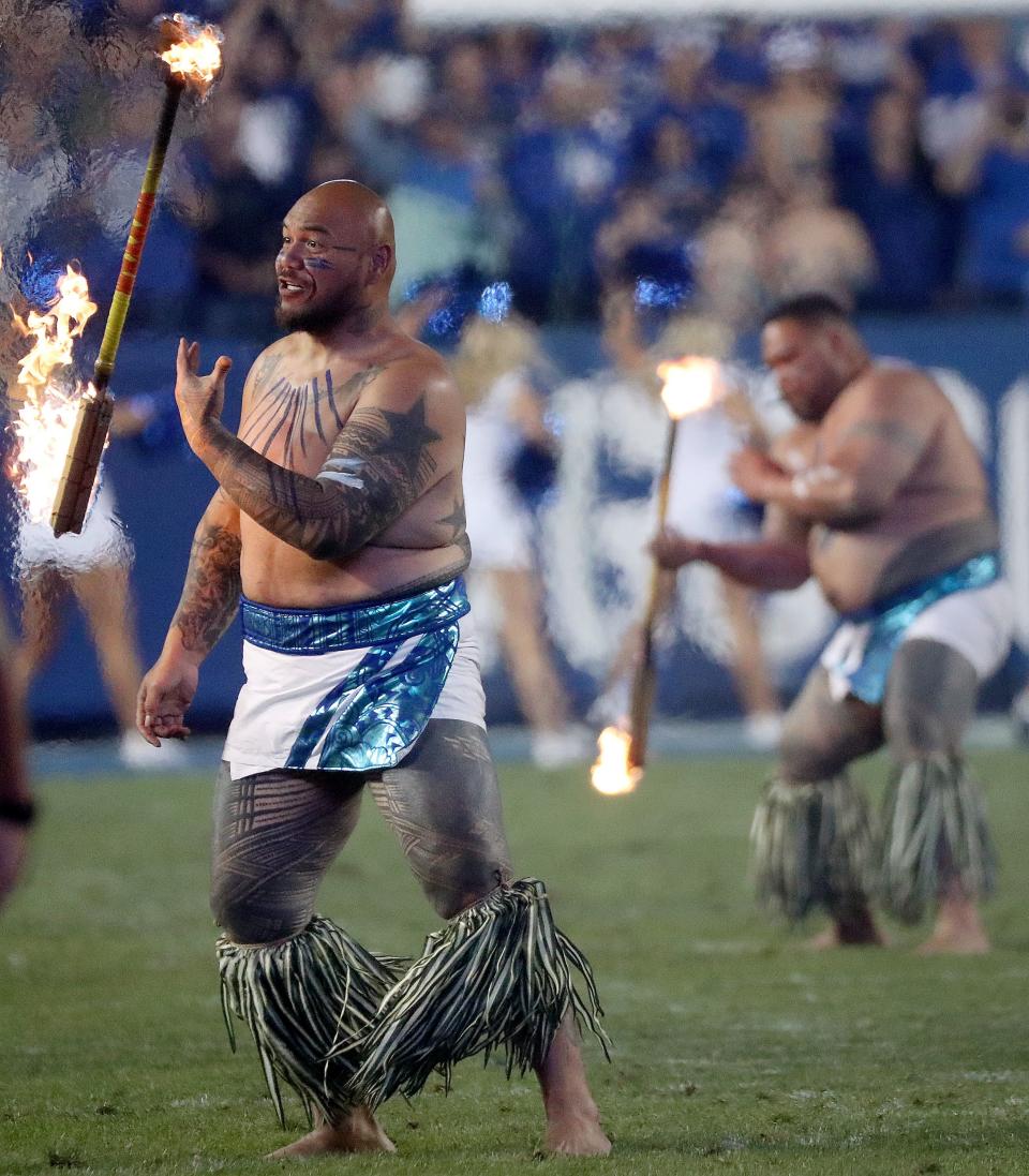 Performers spin fire during a break in a football game between the Brigham Young Cougars and the Cincinnati Bearcats at LaVell Edwards Stadium in Provo on Friday, Sept. 29, 2023. BYU won 35-27. | Kristin Murphy, Deseret News