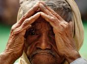 A supporter of India's main opposition Bharatiya Janata Party shades his eyes from the sun as he listens to a speaker at a rally against price rise in New Delhi, India, Wednesday, Feb. 10, 2010. India's food price rises drove a 7.3 percent jump in the headline wholesale price index in December, and inflation has begun to spread to non-food sectors as well, according to the government. (AP Photo/Gurinder Osan)